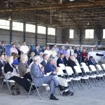 Roughly 100 individuals gathered at 11 a.m. at the WPA Hangar at the airport that was the first building constructed at the airport under the Federal Works Progress Administration Program and dedicated in 1937.