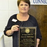 McKinney holds her plaque for being named the Clanton Evening Lions Club's 2013 Pillar of the Community.