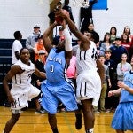 Jemison's ShunDerrius Strong (right) blocks a shot attempt by Calera's ShaKeith Tyes.