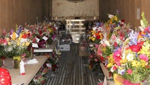 A truck sits in the parking lot of Pinedale Gardens filled with bouquets of flowers (pictured) to be delivered for Valentine's Day. Pinedale Gardens owner Becky Patterson estimates her shop will sell more than 5,000 red roses before the end of the day on Friday.