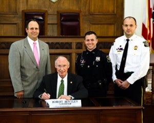 Bentley signs a House Joint Resolution for Officer Patrick Quinley, CPD's 2012 Officer of the Year. 