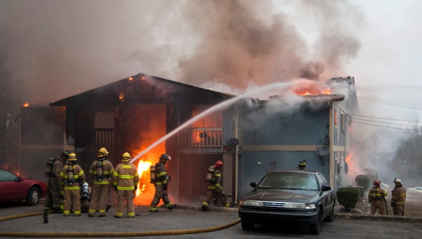 Firefighters battle a blaze Tuesday evening at the Rolling Oaks Apartments complex in Clanton.