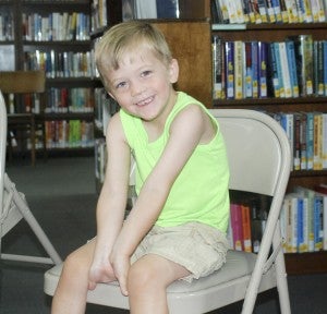 Briar Denson enjoys listening to a reading at the Maplesville summer reading program.