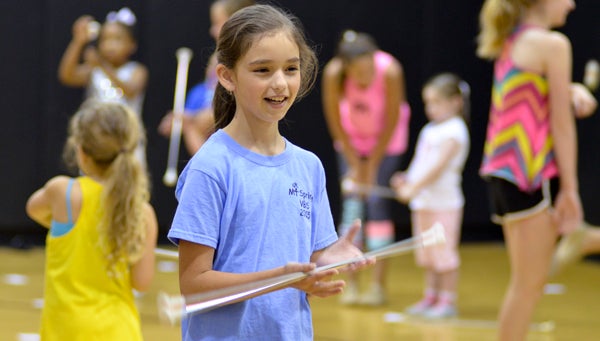 Avree Parrish, 11, practices twirling her baton at the clinic on Tuesday. (Photos by Emily Reed)