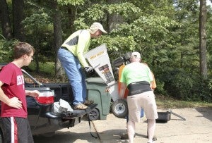 Community support: Some of Scott’s colleagues from Regions Bank help unload equipment used during a service day Aug. 8 at Scott’s home in Clanton.