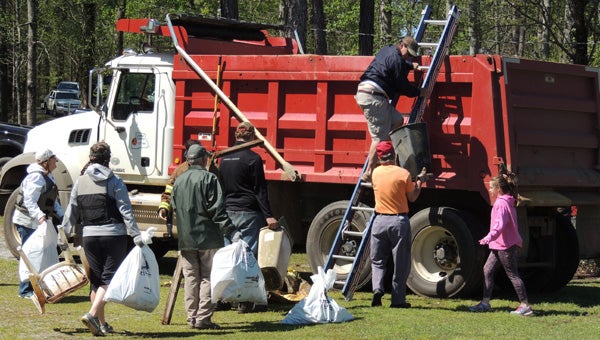 Hard work: Juliana Davis (wearing a pink jacket) helps at the Renew Our Rivers clean-up on April 2. (Photos by Peggy Bullard)