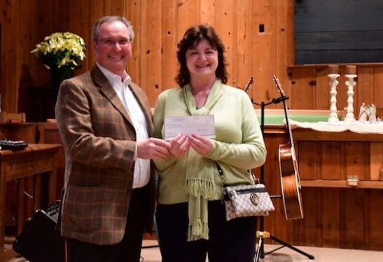 Robin White of Alabama Power presents a check to Pam Persons, treasurer of Chestnut Creek Heritage Chapel, for an energy efficient heating and cooling system for the chapel. (Joyanna Love/Advertiser) 